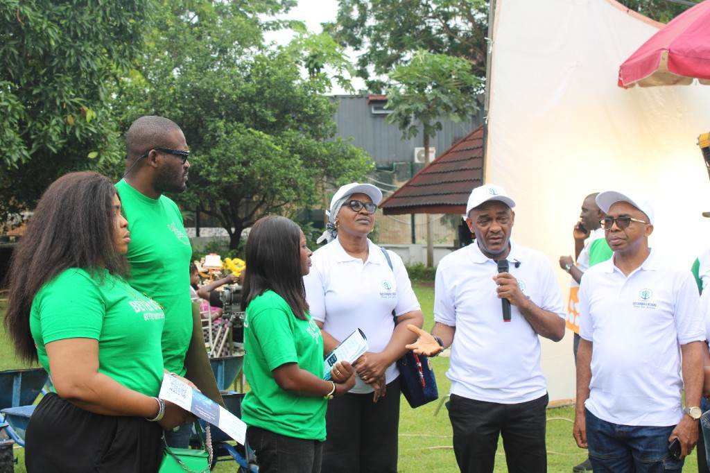 A multidisciplinary team in conversation during a field sustainability briefing.